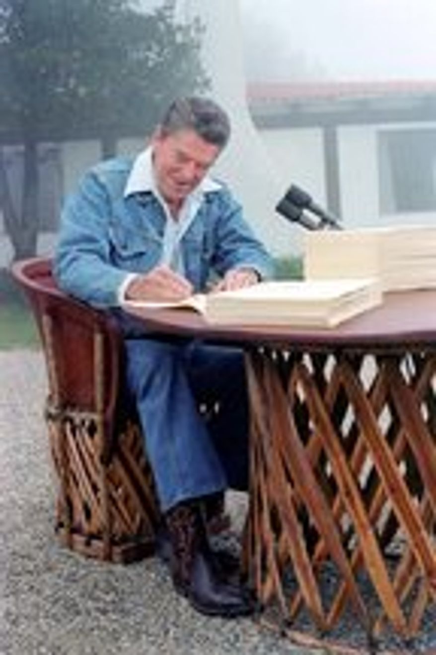 ** FILE ** President Reagan signs the Economic Tax Recovery Act on Aug. 13, 1981. (Ronald Reagan Library)