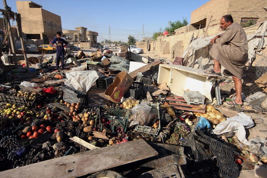 People inspect the aftermath of a car bomb attack in Karbala, 50 miles (80 kilometers) south of Baghdad, Iraq, Sunday, Aug. 11, 2013. A wave of car bombings targeting those celebrating the end of Ramadan across Iraq killed scores of people Saturday, a bloody reminder of the inability of Iraqi authorities to stop violence threatening to spiral out of control. (AP Photo)