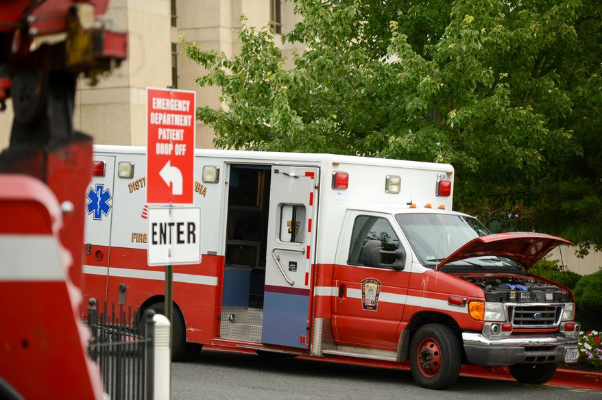 An ambulance sits broken down outside Washington Hospital Center, Washington, D.C., Tuesday, August 13, 2013. (Andrew Harnik/The Washington Times)