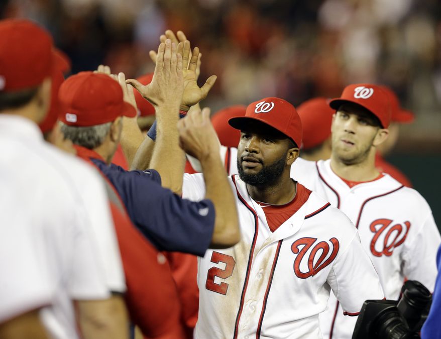 The Washington Nationals celebrate their fifth straight victory on Wednesday night. (Associated Press photo)