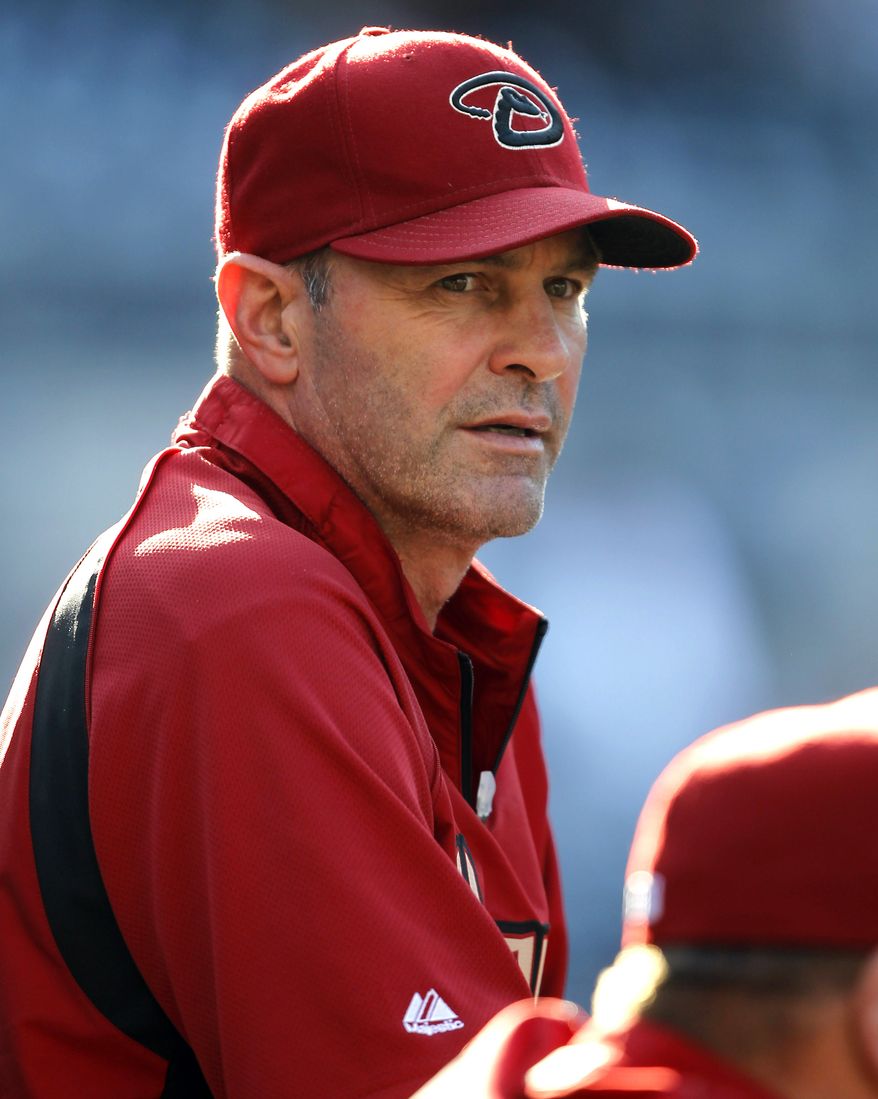 FILE - In this Sept. 17, 2011, file photo, Arizona Diamondbacks manager Kirk Gibson watches batting practice before playing against the San Diego Padres in a baseball game in San Diego. Gibson said Sunday, Aug. 18, 2013, that "cheaters" like Ryan Braun rob other players of opportunities for moments such as his pinch-hit home run during the ninth inning of Game 1 of the 1988 World Series for the Los Angeles Dodgers. (AP Photo/Alex Gallardo, File)