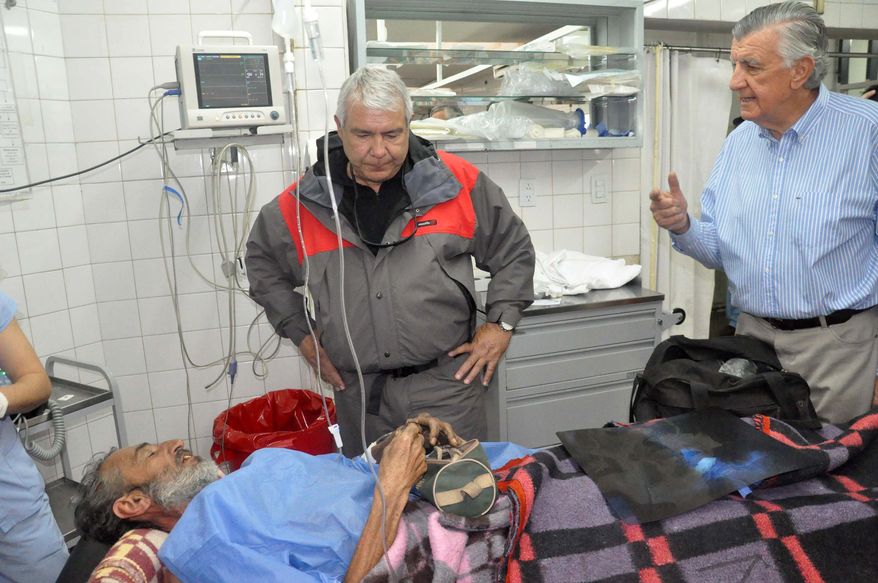 Uruguayan Raul Gomez talks with San Juan's state Gov. Jose Gioja (right) as he recovers at a hospital in San Juan, Argentina, on Sept. 8, 2013. The 58-year-old man who spent four months lost while trying to walk across the Andean mountains is recovering in an Argentine hospital. It wasn't clear at first what led Gomez with apparently no mountaineering experience to make the trek from Chile. Now it turns out that Gomez was fleeing from the law. Chilean authorities say child sex abuse charges were filed against him in April. (Associated Press)