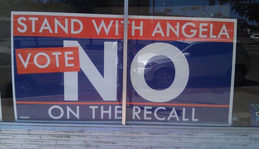 A sign outside state Sen. Angela Giron's campaign headquarters in Pueblo, Colo., urges voters to oppose the recall. (Valerie Richardson/The Washington Times)