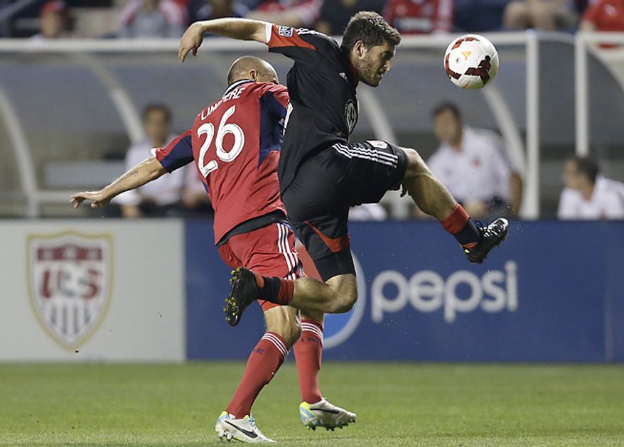 ** FILE ** D.C. United defender Chris Korb, right, controls the ball against Fire midfielder Joel Lindpere. (Associated Press)