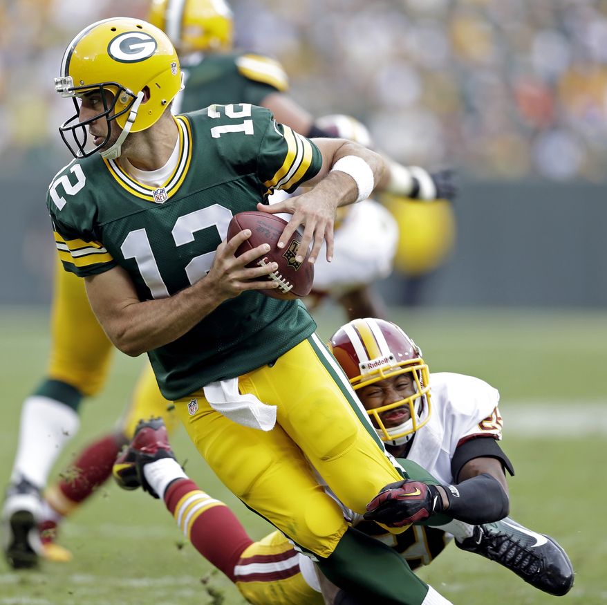 Washington Redskins' Josh Wilson sacks Green Bay Packers quarterback Aaron Rodgers during the second half of an NFL football game Sunday, Sept. 15, 2013, in Green Bay, Wis. (AP Photo/Tom Lynn)