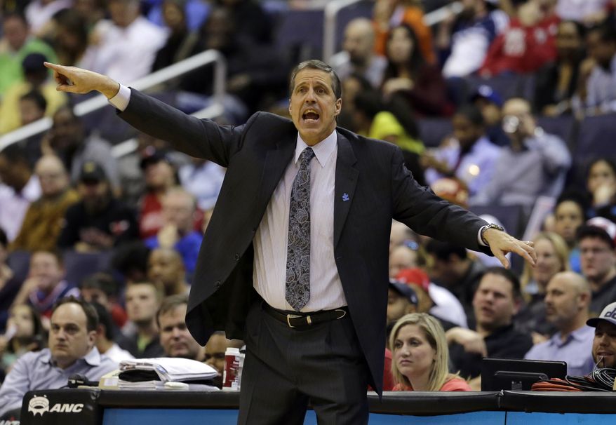 FILE - In this April 2, 2013 file photo, Washington Wizards head coach Randy Wittman directs his team in the first half of an NBA basketball game against the Chicago Bulls in Washington. The aim is pretty clear for Wall and the rest of the Washington Wizards: get to the postseason. Team president Ernie Grunfeld says so. As does coach Randy Wittman. Speaking at a joint news conference Wednesday, Grunfeld says, "Our initial goal is to be a playoff contender and, ultimately, by the end of the year, make the playoffs." Wittman adds, "We want to make the playoffs. ... And there's no reason why we can't." Washington went 29-53 last season, missing out on the postseason for the fifth consecutive year.(AP Photo/Alex Brandon, File)