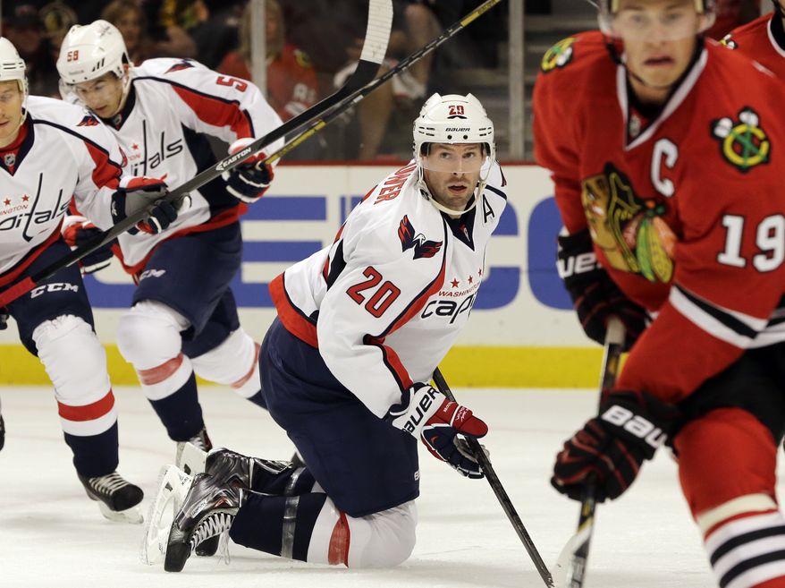 Washington Capitals' Troy Brouwer (20) watches the puck during the first period of an NHL preseason hockey game against the Chicago Blackhawks in Chicago, Saturday, Sept. 28, 2013. (AP Photo/Nam Y. Huh)