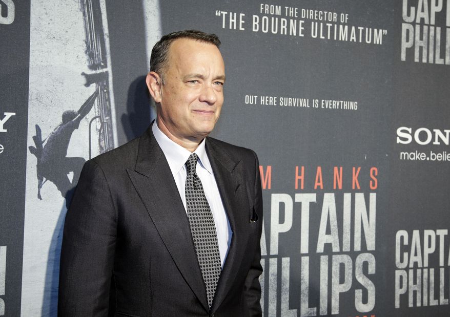 Tom Hanks poses for photographers as he walks the red carpet at a screening for the movie "Captain Phillips" at the Newseum, Wednesday, Oct. 2, 2013 in Washington. (AP Photo/Alex Brandon)