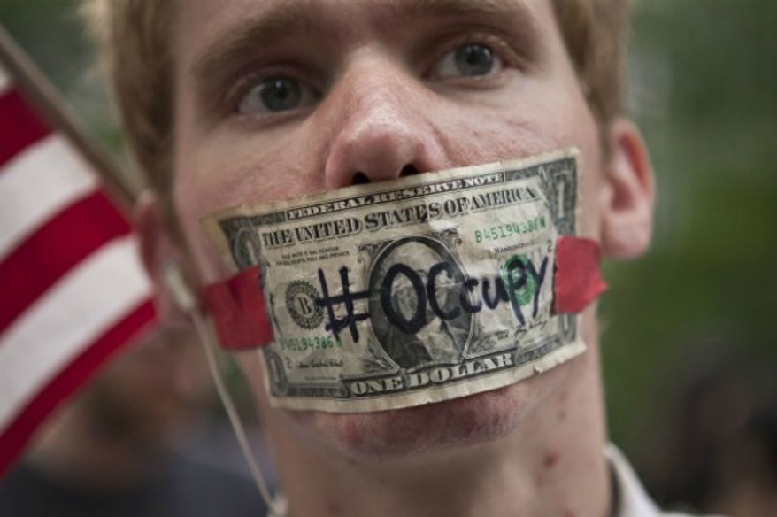 ** FILE ** An "Occupy Wall Street" protester in Zuccotti Park in New York, Oct. 10, 2011. (AP Photo/Andrew Burton)