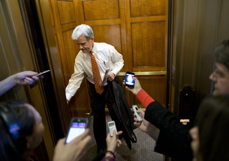 Sen. Tom Coburn, R-Okla., is pursued by members of the media as he gets on an elevator on Capitol Hill in Washington, Tuesday, Oct. 8, 2013, after leaving a Republican policy luncheon. (AP Photo/Evan Vucci)