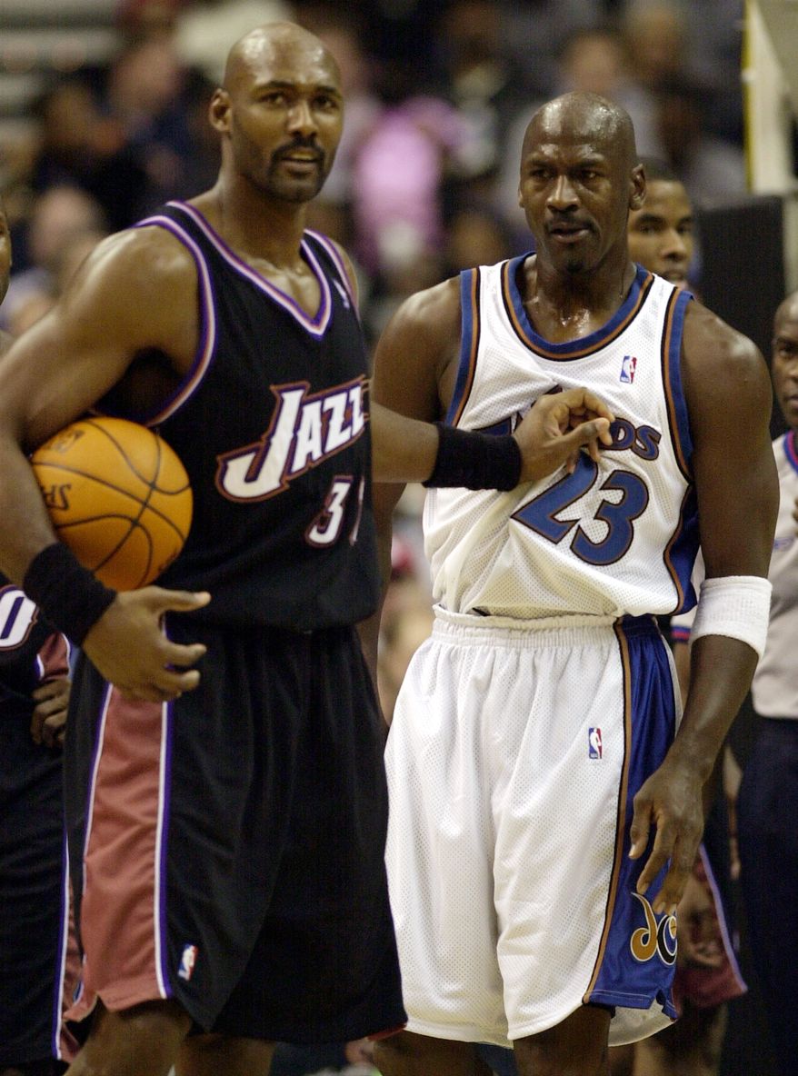 Washington Wizards' Michael Jordan (23) gets a shove by Utah Jazz's Karl Malone, left, during the third quarter of the Wizards' 105-102 win, Thursday, Nov. 14, 2002, at the MCI Center in Washington. (AP Photo/Nick Wass)