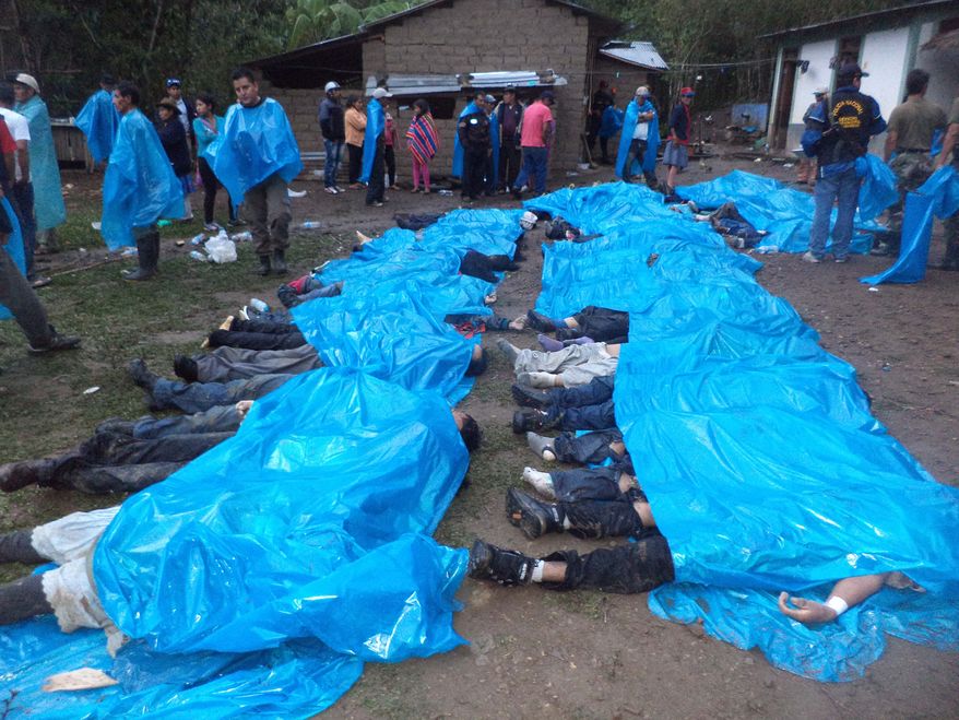 Bodies of victims lie under plastic sheets after they were recovered from a cliff near the twon of Santa Teresa, Cuzco province, Peru, Saturday, Oct. 12, 2013. A makeshift bus carrying 51 Quechua Indians back from a party plunged off a cliff into a river Friday night near the provincial capital of Santa Teresa, an area about 310 miles (500 kilometers) southeast of Lima, killing everyone on board, including 14 children according to Santa Teresa police.(AP Photo/La Republica Newspaper)