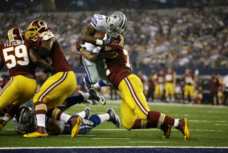 Dallas Cowboys running back Joseph Randle (21) is stopped by Washington Redskins defensive end Stephen Bowen (72) in the second half of an NFL football game, Sunday, Oct. 13, 2013, in Arlington, Texas. (AP Photo/Tim Sharp)