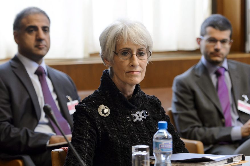 U.S. Under Secretary for Political Affairs Wendy Sherman, center, waits for the start of the two days of closed-door nuclear talks on Tuesday, Oct. 15, 2013, at the United Nations offices in Geneva, Switzerland. Iran's overtures to the West are being tested as the U.S. and its partners sit down for the first talks on Tehran's nuclear program since the election of a reformist Iranian president. Negotiations between Iran and the U.S., Russia, China, Britain, France and Germany began Tuesday morning. (AP Photo/Fabrice Coffrini, pool)