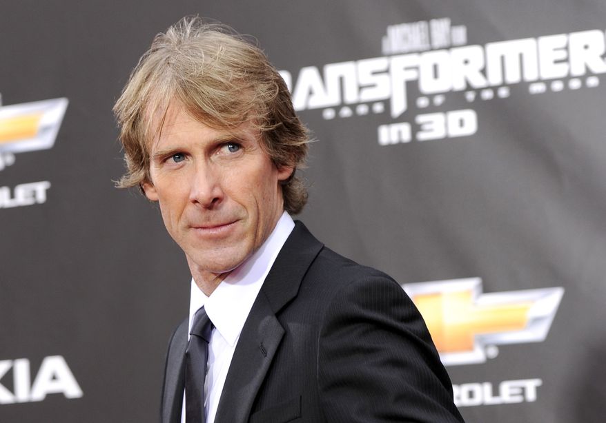FILE - In this June 28, 2011 file photo, executive producer and director Michael Bay attends the "Transformers: Dark Of The Moon" premiere in Times Square in New York. Filming of Hollywood movie Transformers 4 in Hong Kong was briefly suspended after director Bay fell victim to an extortion attempt in which he was slightly injured, according to media reports and police Thursday, Oct. 17, 2013. (AP Photo/Evan Agostini, File)