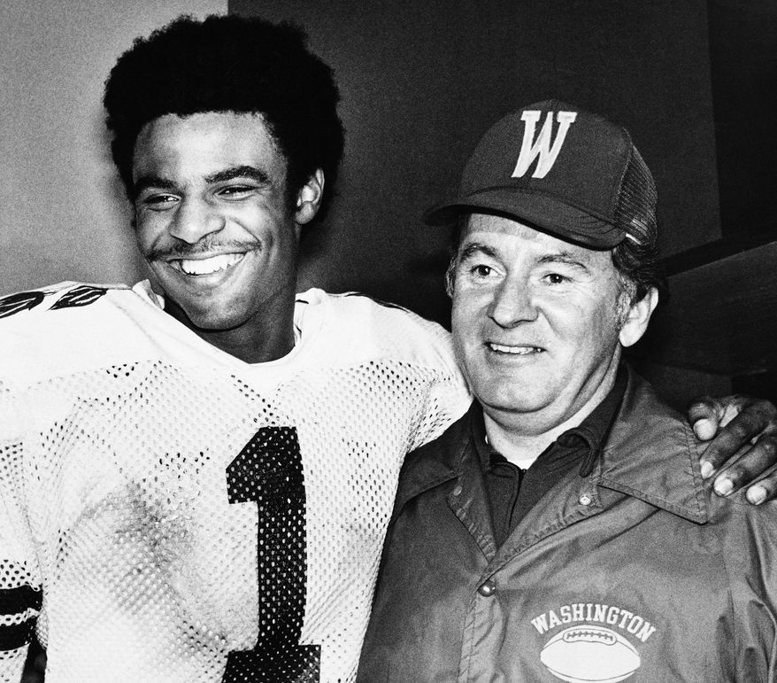 Washington Huskies Warren Moon (l) stands with his coach, Don James, in Washington’s locker room after the Rose Bowl Game in Pasadena on Monday, Jan. 2, 1978. Moon was named “Most Valuable Player” of the Rose Bowl game. (AP Photo)