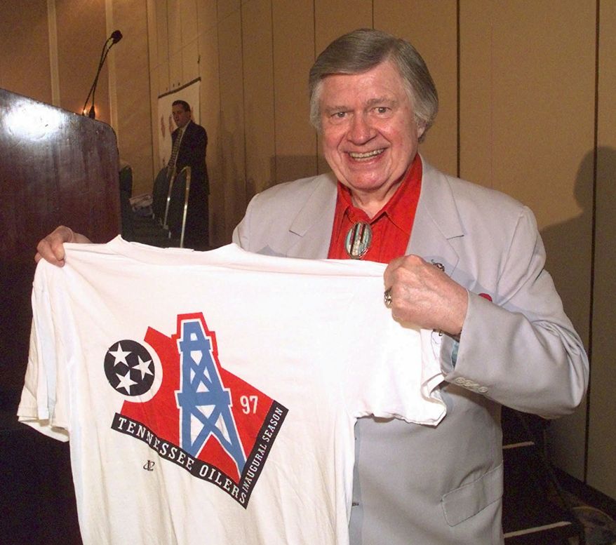 FILE -- This is a June 12, 1997, file photo shows Houston Oilers owner Bud Adams showing off a T-shirt, in Nashville, with the new logo the team will use when it moves to Tennessee. (AP Photo/Mark Humphrey, File)