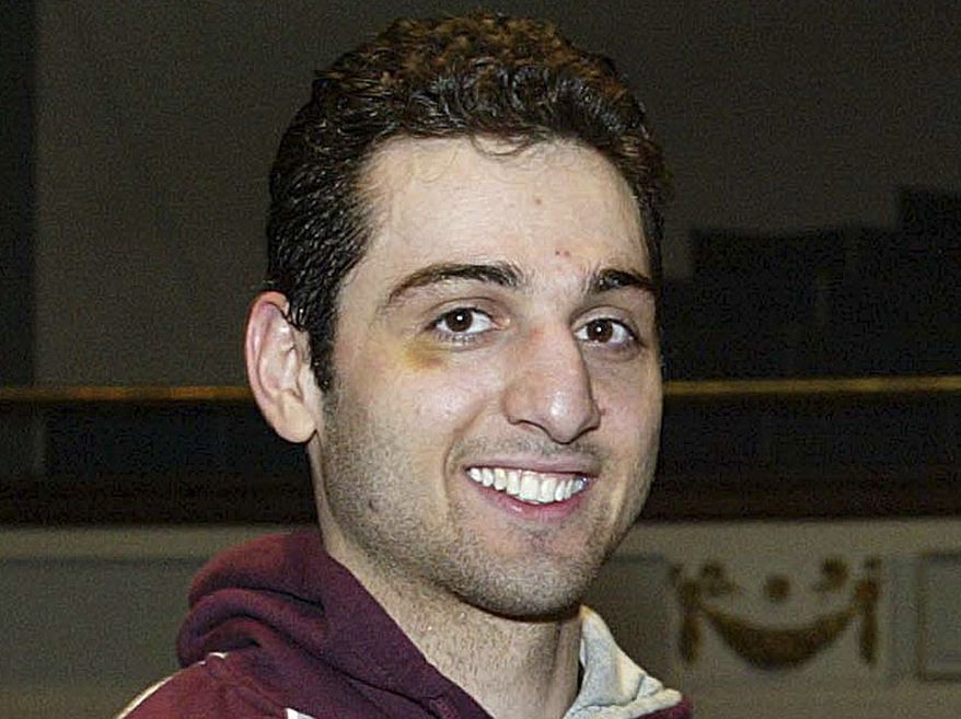 ** FILE ** In this Feb. 17, 2010, file photo, Tamerlan Tsarnaev smiles after accepting the trophy for winning the 2010 New England Golden Gloves Championship in Lowell, Mass. Prosecutors in the case against Boston Marathon bombing suspect Dzhokhar Tsarnaev, Tamerlan's brother, say a man shot to death during questioning by an agent in Florida told investigators that Tamerlan had been involved in a triple homicide (AP Photo/The Lowell Sun, Julia Malakie File)