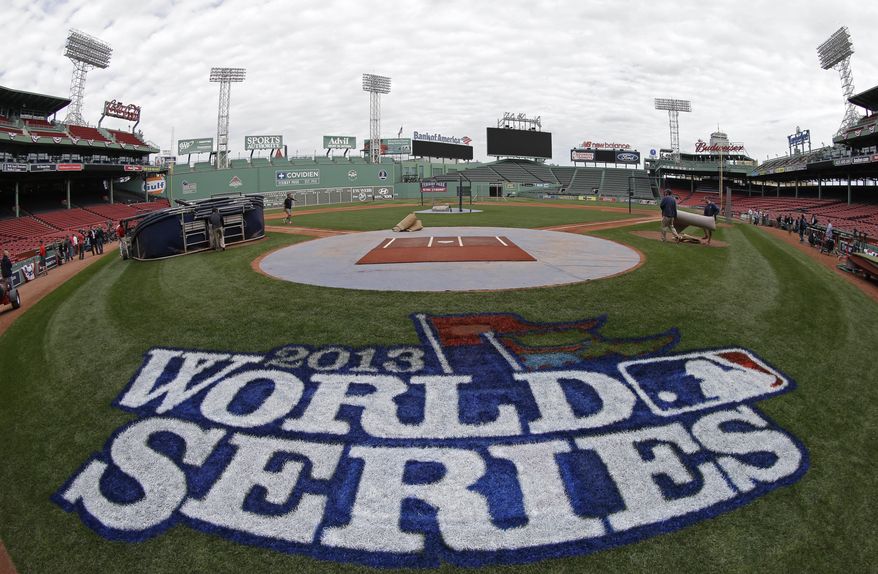 A logo is painted on the field behind home plate at Fenway Park for baseball's World Series Tuesday, Oct. 22, 2013, in Boston. The St. Louis Cardinals face the Boston Red Sox in Game 1 on Wednesday. (AP Photo/David J. Phillip)