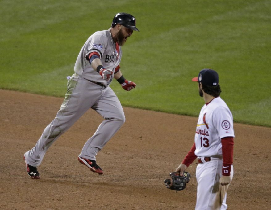 Boston Red Sox's Jonny Gomes reacts after hitting a three-run home run as he runs past St. Louis Cardinals' Matt Carpenter during the sixth inning of Game 4 of baseball's World Series Sunday, Oct. 27, 2013, in St. Louis. (AP Photo/Charlie Riedel)