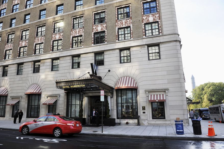 The W Hotel in Washington, Monday, Oct. 28, where singer Chris Brown was arrested, accused of punching a man in the face after the man said he tried to get into a photo with the singer outside the hotel, according to police, the latest legal trouble for the Grammy Award-winning artist. The singer is expected to appear in court Monday on a felony assault charge. Another man, Christopher Hollosy, 35, also was charged with felony assault in the altercation that started just before 4:30 a.m. Sunday, police say. It happened near the W Hotel, not far from the White House. (AP Photo/Cliff Owen)