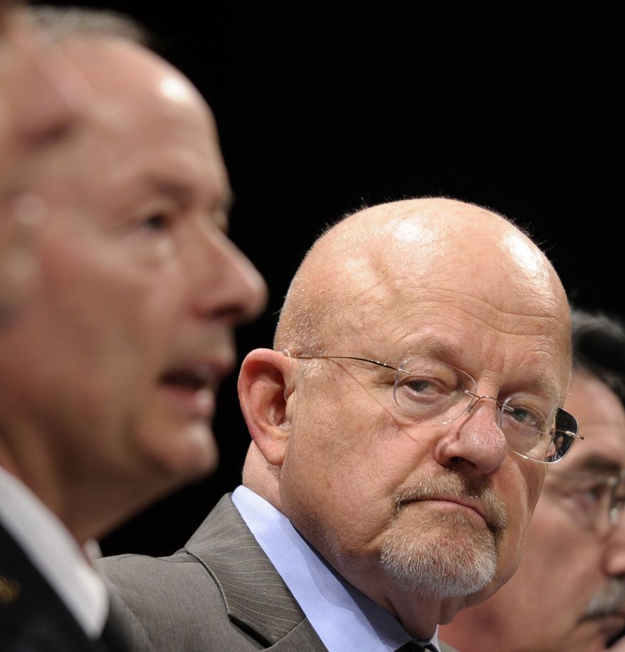 Director of National Intelligence James Clapper listens at right as National Security Agency Director Gen. Keith Alexander, testifies on Capitol Hill in Washington, Tuesday, Oct. 29, 2013, before the House Intelligence Committee hearing on potential changes to the Foreign Intelligence Surveillance Act (FISA). Faced with anger over revelations about U.S. spying at home and abroad, members of Congress suggested Tuesday that programs the Obama administration says are needed to combat terrorism may have gone too far. (AP Photo/Susan Walsh) (AP Photo/Susan Walsh)