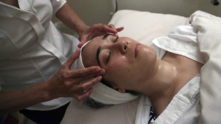 ** FILE ** A customer receives a luxury facial at a spa in New York. (AP Photo/Mary Altaffer)
