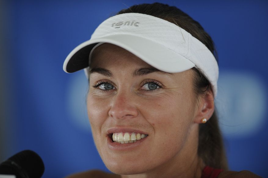 FILE - In this picture taken July 9, 2013 Washington Kastles' Martina Hingis, of Switzerland, attends a press conference prior a World Team Tennis match against the Boston Lobsters, in Washington. Martina Hingis has been questioned by Swiss police after her estranged husband said he was attacked by the five-time Grand Slam champion and her family. Schwyz canton police spokesman Florian Grossmann says Hingis,her mother Melanie Molitor and her mother's boyfriend Mario Widmer were interviewed at its headquarters last week. Grossmann tells The Associated Press the canton justice department will decide possible further action. No timetable was set for a decision. French equestrian athlete Thibault Hutin has said he was attacked on Sept. 23 at his home in Feusisberg. Hutin claimed Hingis and Molitor hit him, and Widmer struck him with a DVD player. (AP Photo/Nick Wass, File)
