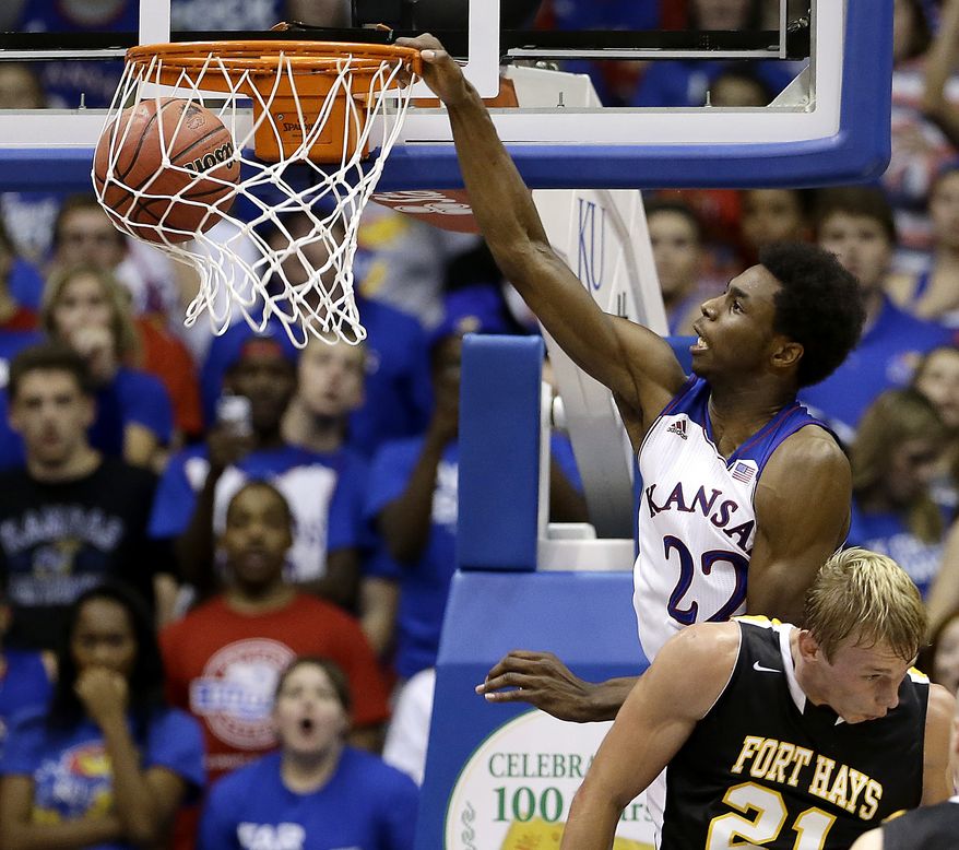 Kansas' Andrew Wiggins (22) gets past Fort Hays State's Jake Stoppel to dunk the ball during the second half of an exhibition NCAA college basketball game Tuesday, Nov. 5, 2013, in Lawrence, Kan. Kansas won the game 92-75. (AP Photo/Charlie Riedel)