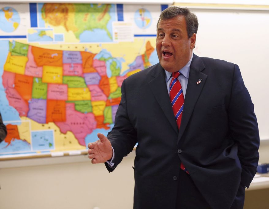 New Jersey Gov. Chris Christie visits a school a day after his landslide win. Tea partyers say the Republican National Committee spent money on his campaign that should have gone to Kenneth T. Cuccinelli II in Virginia. (Associated Press)