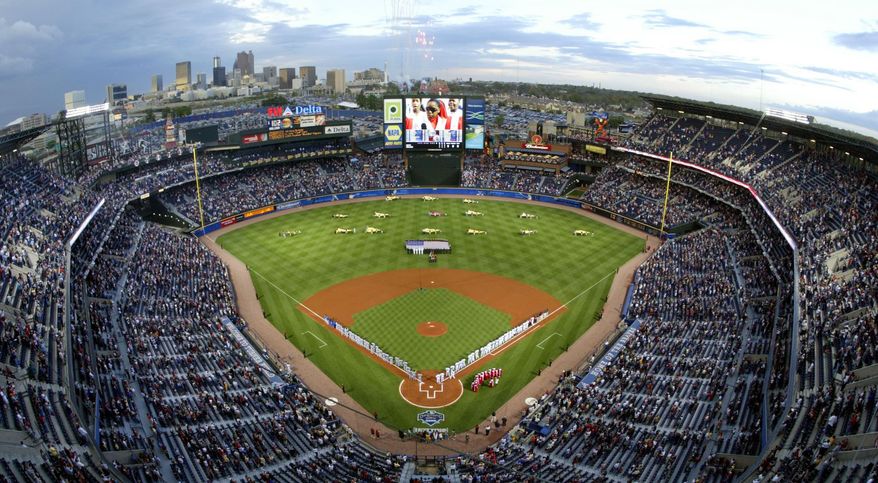 FILE - In this April 8, 2005 file photo, The Atlanta Braves, right, and the New York Mets stand on the baselines at Turner Field in Atlanta during opening day ceremonies. The Atlanta Braves are leaving Turner Field and moving into a new 42,000-seat, $672 million stadium complex in Cobb County in 2017. Braves executives John Schuerholz, Mike Plant and Derek Schiller said Monday, Nov. 11, 2013, that the team decided not to seek another 20-year lease at Turner Field and began talks with the Cobb Marietta Coliseum and Exhibit Hall Authority in July.(AP Photo/John Bazemore/File)
