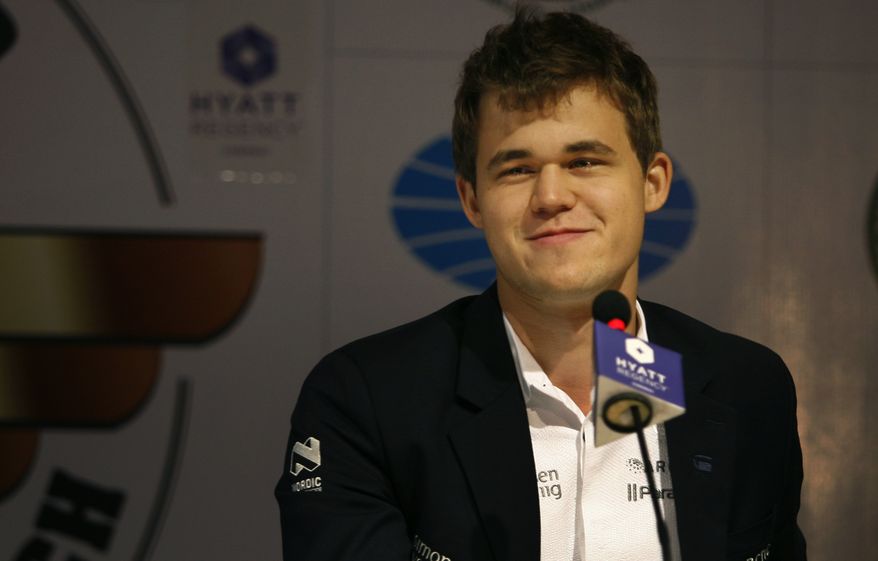 ** FILE ** Norway's Magnus Carlsen interacts with the media after a match against reigning world chess champion Viswanathan Anand of India during the chess world championship match in Chennai, India, Tuesday, Nov. 19, 2013. Carlson, 22, is the top Western player since Bobby Fischer in a game that has traditionally been dominated by Russians, and chess enthusiasts hope his mass-market appeal can win over new fans and help boost interest worldwide. (AP Photo/Arun Sankar K )