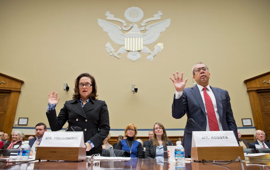 Harriet Tregoning, director of the District of Columbia Office of Planning, and Marcel Acosta, executive director of the National Capital Planning Commission, gave differing views Monday about whether height limits on buildings in the District should be eased. Restrictions were passed 103 years ago to preserve the view of landmarks such as the Capitol (below in 1931, bottom in 2001). Those in favor of an easing say it will help the District expand its tax base.
Harriet Tregoning, director of the District of Columbia Office of Planning, left, and Marcel Acosta, executive director of the National Capital Planning Commission, right, are sworn in on Capitol Hill in Washington, Momday, Dec. 2, 2013, prior to testifying before the House Oversight Committee hearing about whether the historic height limits on buildings in Washington, D.C., should be changed. The Height Act of 1910 generally requires that buildings in the District of Columbia be no taller than the width of the streets they face. (AP Photo/J. Scott Applewhite) (associated press photographs)