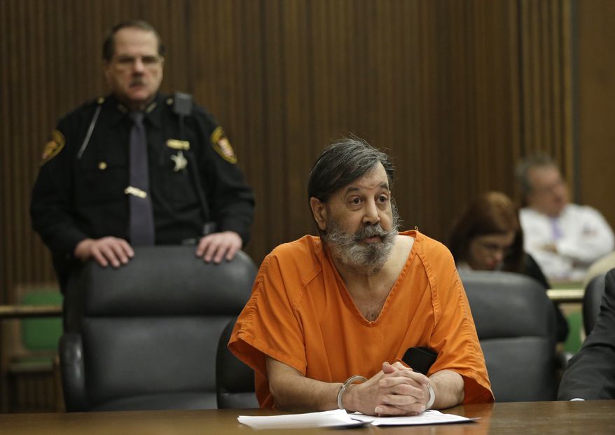 John Donald Cody, who identifies himself as Bobby Thompson, speaks during his sentencing hearing on racketeering, theft and money-laundering charges on Monday, Dec. 16, 2013, in Cleveland. (AP Photo/Mark Duncan)