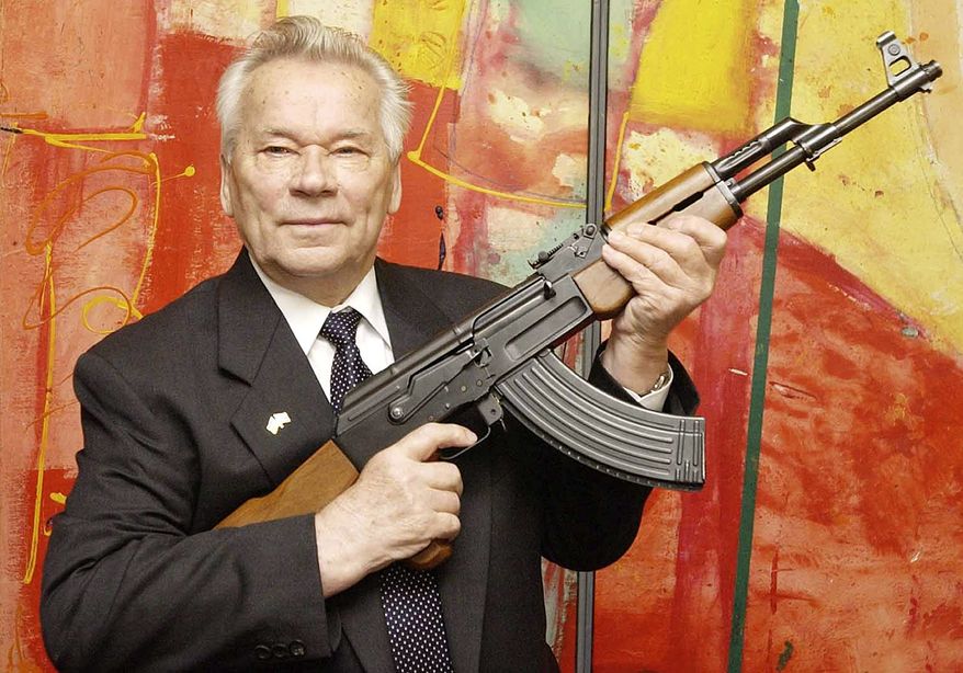 FILE - In this July 26, 2002 file photo, Russian weapon designer Mikhail Kalashnikov presents his legendary assault rifle to the media while opening the exhibition "Kalashnikov - legend and curse of a weapon" at a weapons museum in Suhl, Germany. Mikhail Kalashnikov, whose work as a weapons designer for the Soviet Union is immortalized in the name of the world’s most popular firearm, has died at the age of 94, Monday Dec. 23, 2013. (AP Photo/Jens Meyer, File)