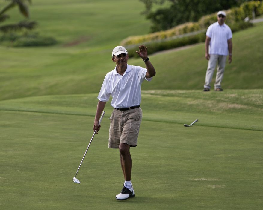 President Barack Obama waves to the gallery watching him play on the 18th green at the Mid Pacific Country Club, Wednesday, .Jan. 1, 2014 in Lanikai on the island of Oahu, in Hawaii. (AP Photo/Marco Garcia)