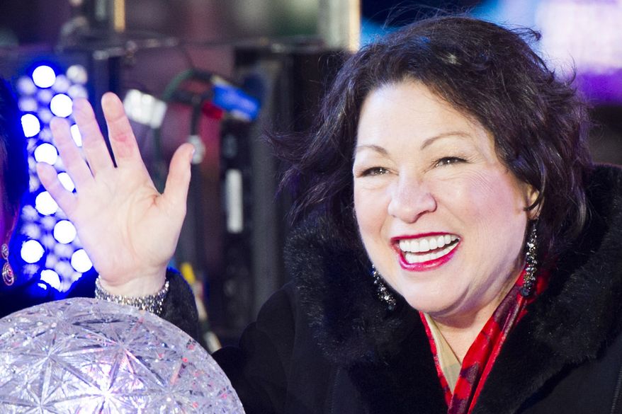 U.S. Supreme Court Justice Sonia Sotomayor pushes the Waterford crystal button that signals the descent of the New Year's Eve Ball in Times Square on Tuesday, Dec. 31, 2013 in New York. (Photo by Charles Sykes/Invision/AP)