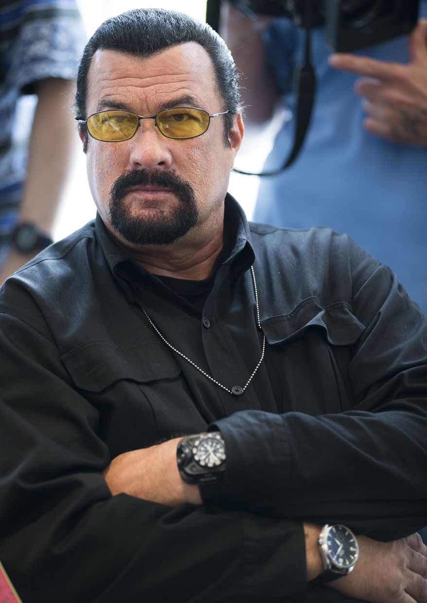 This June 2, 2013, file photo shows actor Steven Seagal looking on as he waits for a news conference of the U.S. congressional delegation to Russia in the U.S. Embassy in Moscow, Russia. (AP Photo/Alexander Zemlianichenko, File)