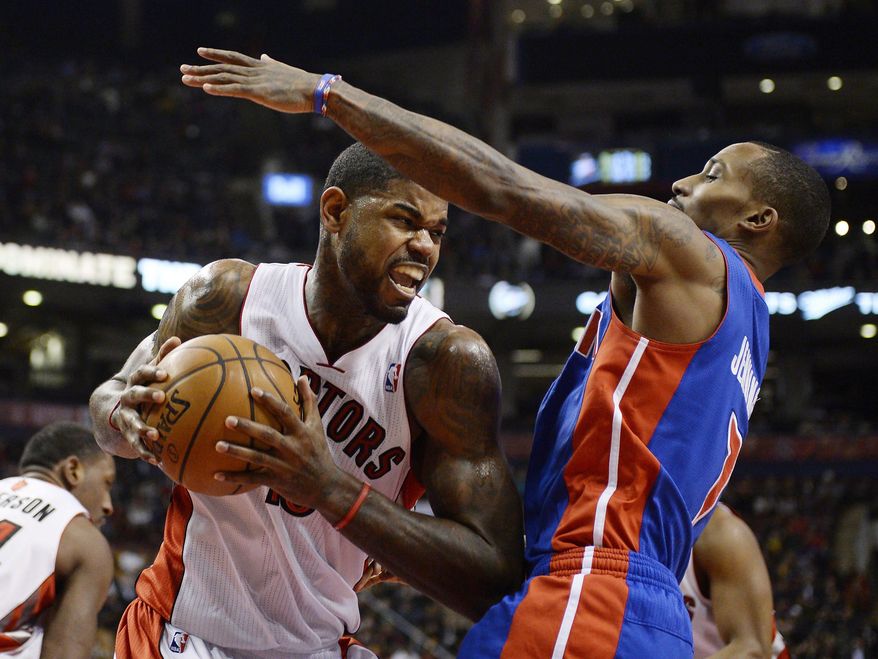 Toronto Raptors forward Amir Johnson, left, drives to the net against Detroit Pistons guard Brandon Jennings during first-half NBA basketball game action in Toronto, Wednesday, Jan. 8, 2014. (AP Photo/The Canadian Press, Frank Gunn)