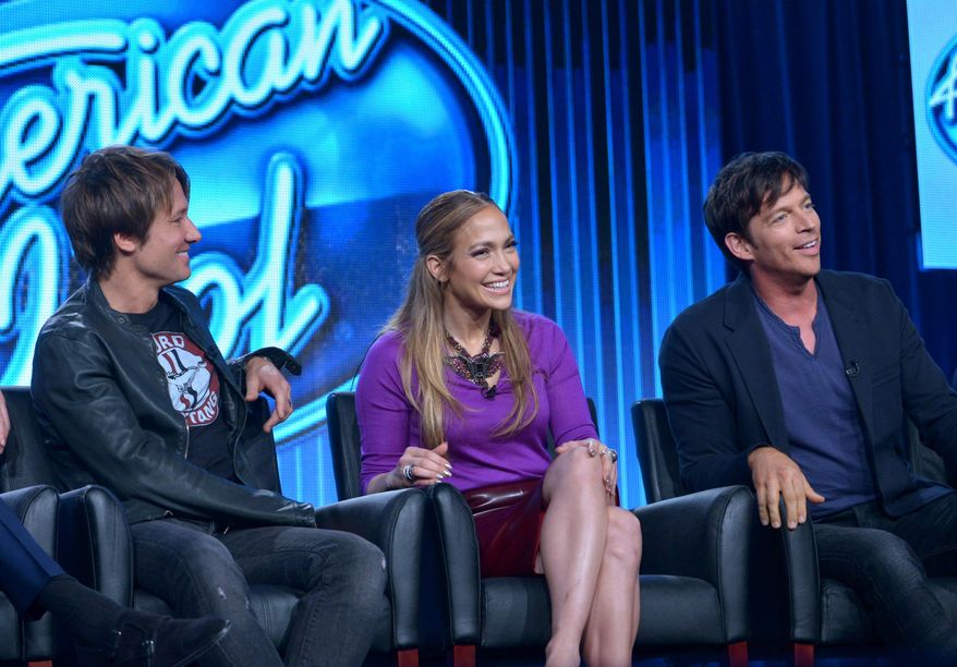 Judges, from left, Keith Urban, Jennifer Lopez, and Harry Connick Jr. are seen during the panel of "American Idol" at the FOX Winter 2014 TCA, on Monday, Jan. 13, 2014, at the Langham Hotel in Pasadena, Calif. The producers of the show say the new season includes changes to freshen it, including an expanded song list for contestants. Executive producer Per Blankens said Monday, Jan. 13, 2014, that the show's song list, which has included a fair share of golden oldies, will add more current tunes that the young contestants can relate to. (Photo by Richard Shotwell/Invision/AP)