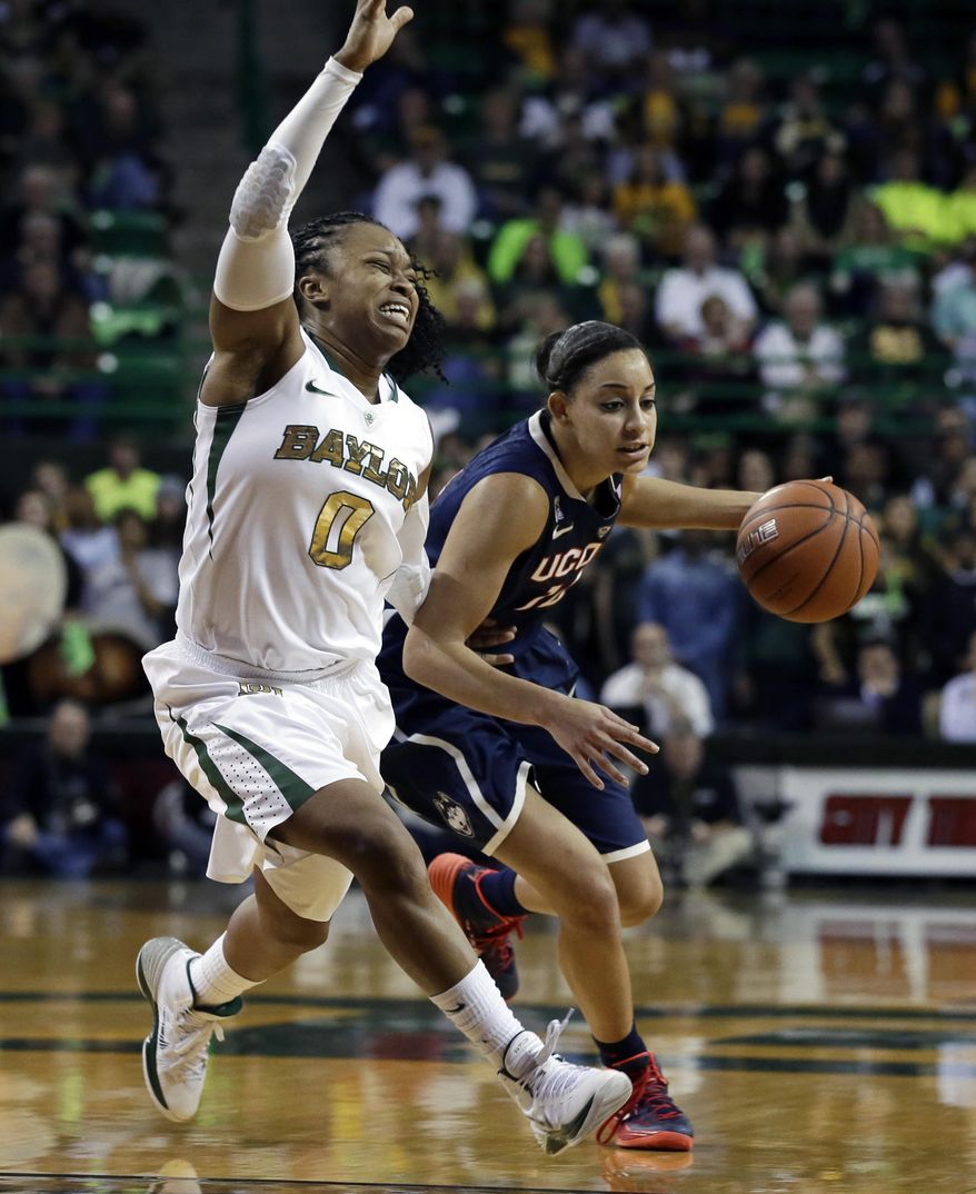 Baylor's Odyssey Sims (0) attempts to cut off a drive around the perimeter by Connecticut's Bria Hartley (14) in the first half of an NCAA basketball game, Monday, Jan. 13, 2014, in Waco, Texas. (AP Photo/Tony Gutierrez)
