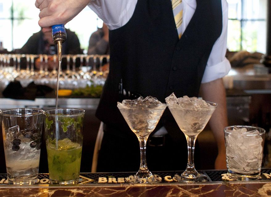 ** FILE ** In this Monday, Nov. 19, 2012, file photo, a bartender prepares alcoholic drinks at a restaurant in San Francisco. (AP Photo/Eric Risberg)