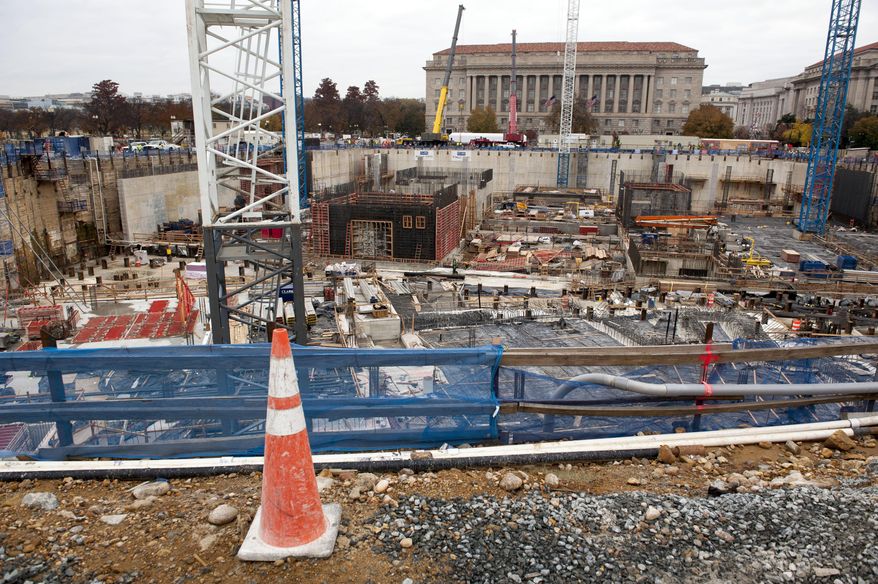 FILE - This Nov. 17, 2013 file photo shows construction continuing on the National Museum of African American History and Culture in Washington. A budget deal approved by Congress restores funding for some national arts and cultural programs, but others will still see reductions. In a funding bill approved this week, lawmakers decided against providing construction money for the planned Dwight D. Eisenhower memorial in Washington. The deal provides $1 million for salaries and expenses of the federal memorial commission, dismissing its $51 million budget request. (AP Photo/Cliff Owen, File)