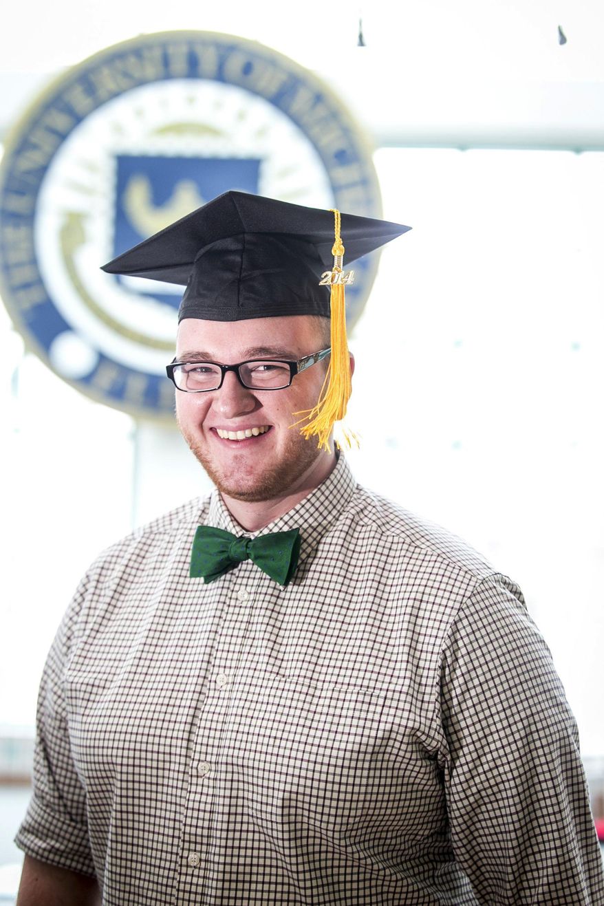 Alex Benda, 22, poses in a gaduation cap at the Michigan Times offices at the University of Michigan-Flint in Flint, Mich. on Friday, Jan. 17, 2014. Bends says he hopes to sell add space on his graduation cap to take a bite out of his education debt. (AP Photo/The Detroit Free Press, Jarrad Henderson) DETROIT NEWS OUT, TV OUT, INTERNET OUT, MAGS OUT, NO SALES, MANDATORY CREDIT DETROIT FREE PRESS