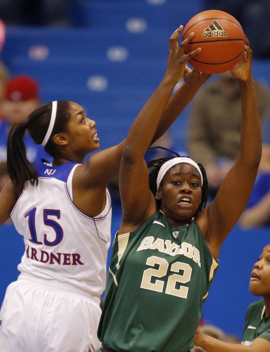 Baylor center Sune Agbuke (22) rebounds against Kansas forward Chelsea Gardner (15) during the first half of an NCAA college basketball game in Lawrence, Kan., Sunday, Jan. 19, 2014. (AP Photo/Orlin Wagner)