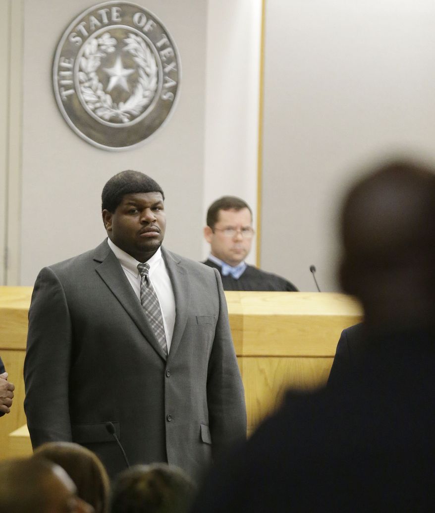 Former Dallas Cowboys Josh Brent stands in court as potential jurors are directed into Judge Robert Burns, looking on in back, courtroom Friday, Jan. 10, 2014, in Dallas. (AP Photo/LM Otero)