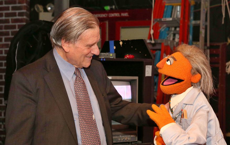 In this May 1, 2012 photo provided by Sesame Workshop, Dr. Valentin Fuster, a cardiologist at New York's Mount Sinai Hospital, stands with a Muppet character based on him, "Dr. Ruster," in the Sesame Street studios in the Queens borough of New York. Fuster, who teamed up with Sesame Street on a project to improve kids' health, has shown progress in a study in Colombia. In 2014, the project is planned to launch in New York in what sponsors hope will be a first step to fight childhood obesity nationwide. (AP Photo/Sesame Workshop, Richard Termine)