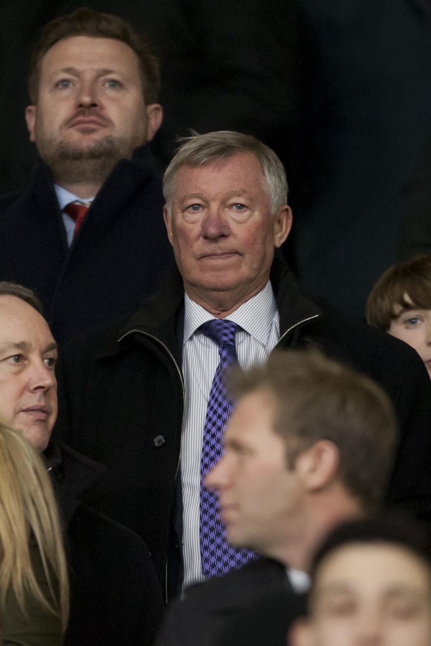 Manchester United's former manager Alex Ferguson takes his seat before the team's English League Cup semifinal second leg soccer match against Sunderland at Old Trafford Stadium, Manchester, England, Wednesday Jan. 22, 2014. (AP Photo/Jon Super)
