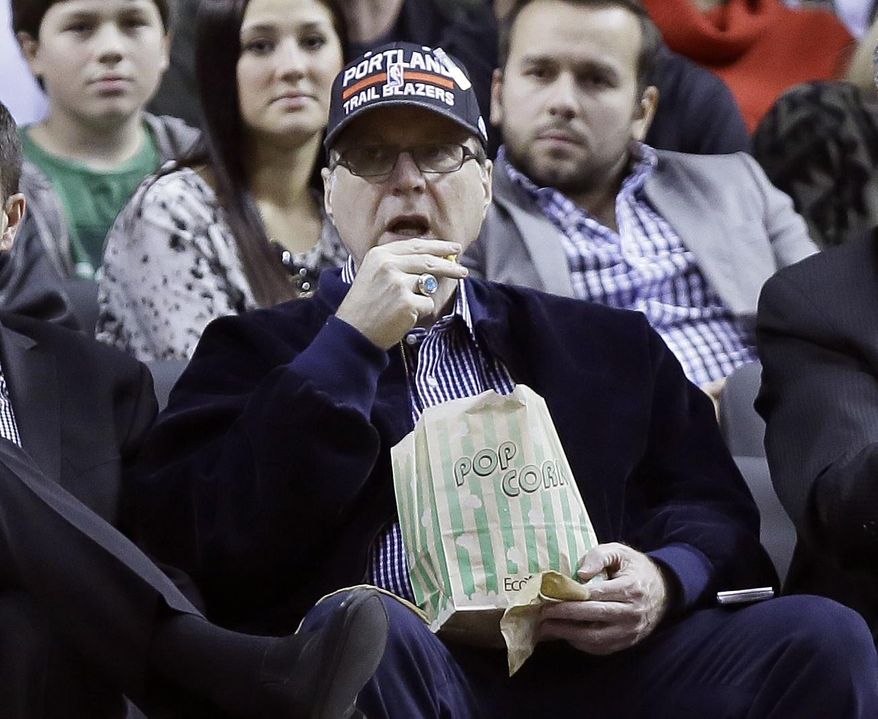 Portland Trail Blazers owner Paul Allen watches from his seat under the basket during the second half of an NBA basketball game against the Denver Nuggets in Portland, Ore., Thursday, Jan. 23, 2014. Portland Won 110-105. (AP Photo/Don Ryan)