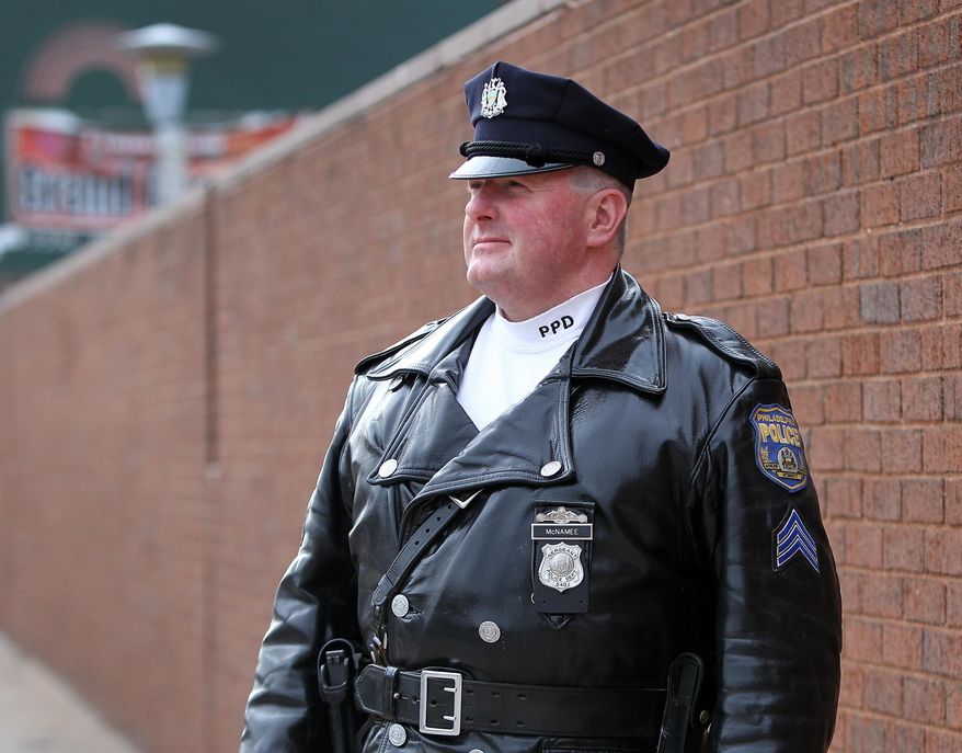 This photo taken Jan. 19, 2014, shows Philadelphia police Sgt. William McNamee posing outside the 35th police district building in Philadelphia, Pa. (AP Photo/Philadelphia Daily News, David Maialetti)